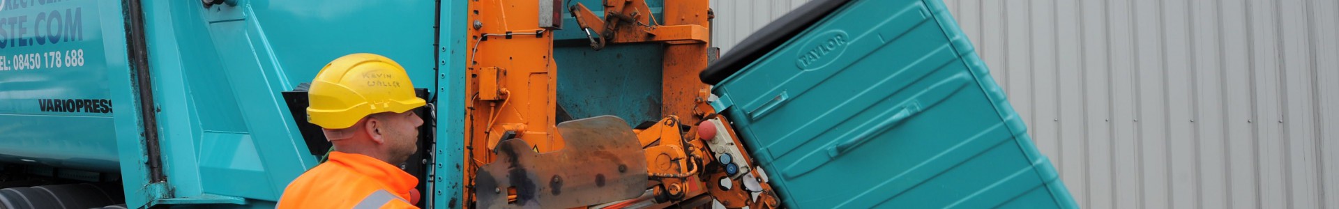A Premier Waste employee providing waste and recycling services.