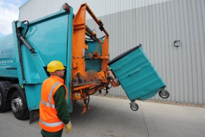 A Premier Waste employee providing waste and recycling services.